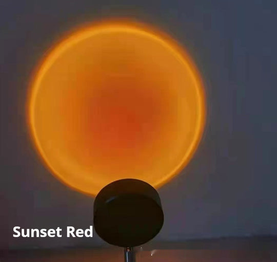 Sunset Projection Lamp displaying warm sunset red light projection effect on a wall.